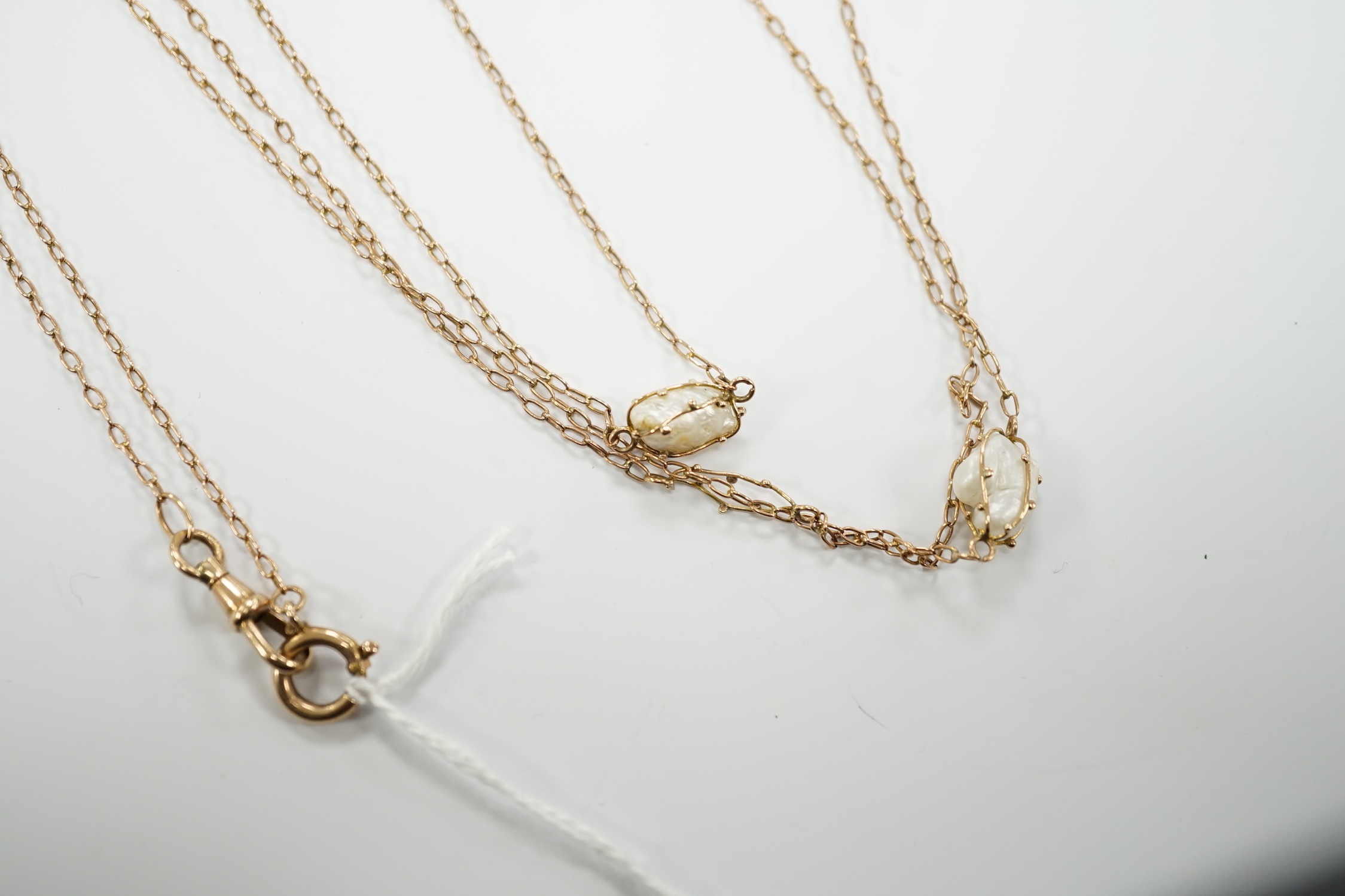 An early 20th century 9ct and eleven stone baroque pearl set long chain, 160cm, gross 13.2 grams.